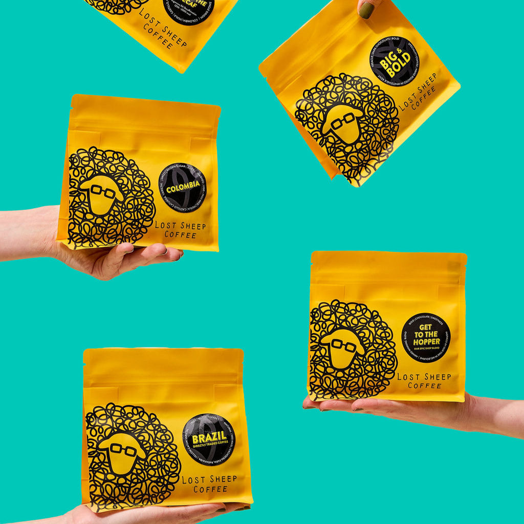 The range of Lost Sheep coffee packaging against a teal background.