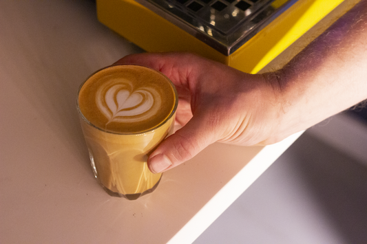 Heart latte art in a glass.